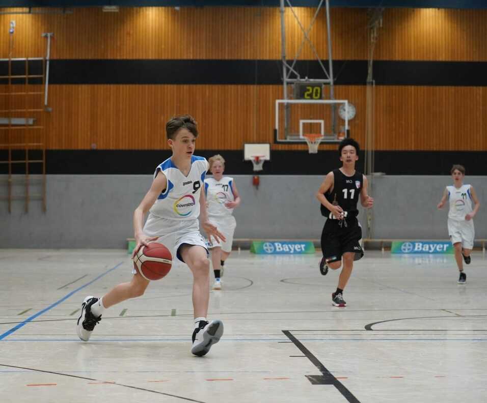 Jugendlicher Basketballspieler mit Ball